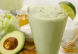 A glass of cantaloupe smoothie with yogurt and honey ready to drink the color made white greenish a sweet taste
