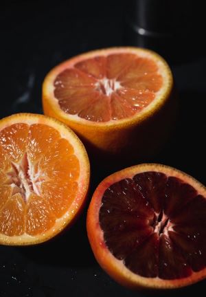 "Comparison of the sweetest in-season oranges: classic navel, pink Cara Cara, and deep red blood orange — all juicy and ready to eat."
